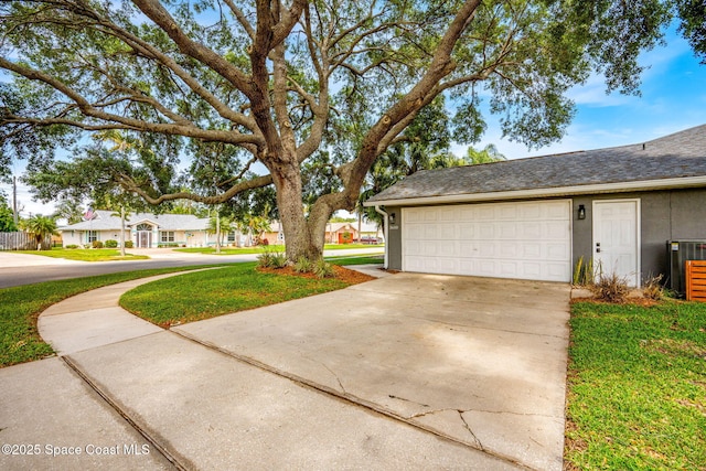 view of side of home with driveway, cooling unit, a residential view, a lawn, and a shingled roof