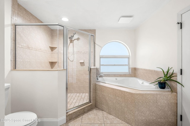 full bathroom featuring tile patterned flooring, a bath, toilet, and a stall shower
