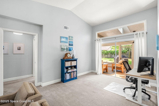 carpeted home office featuring lofted ceiling and baseboards