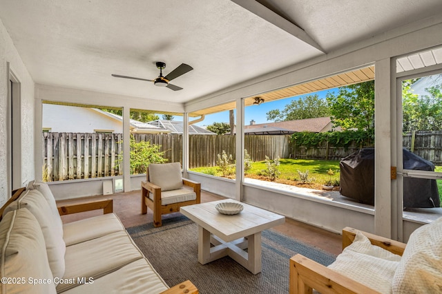 sunroom featuring a ceiling fan, plenty of natural light, and an outdoor living space