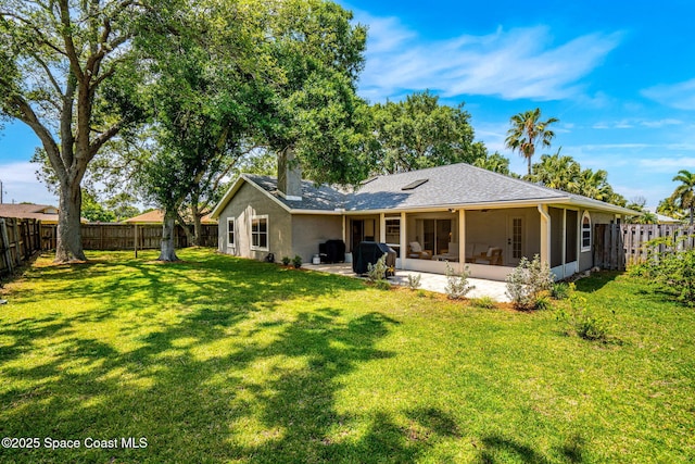 rear view of property featuring stucco siding and a sunroom