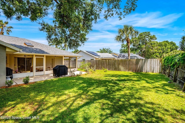 view of yard featuring a patio and a sunroom
