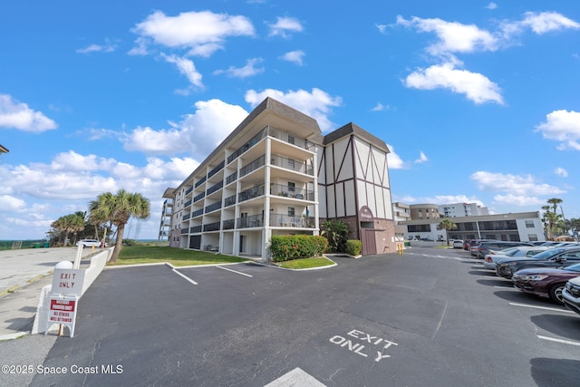 view of property featuring uncovered parking