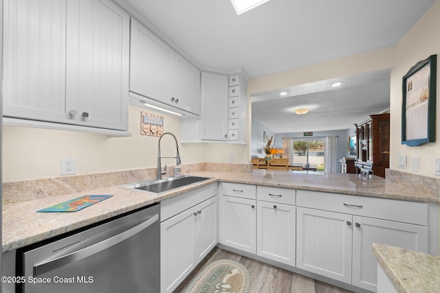 kitchen with a sink, white cabinetry, recessed lighting, light wood-style floors, and dishwasher