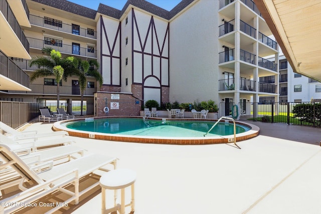 pool featuring a patio area and fence