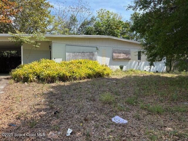 view of side of home with a carport