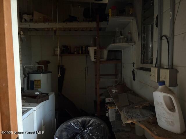 basement with electric water heater and washer and clothes dryer