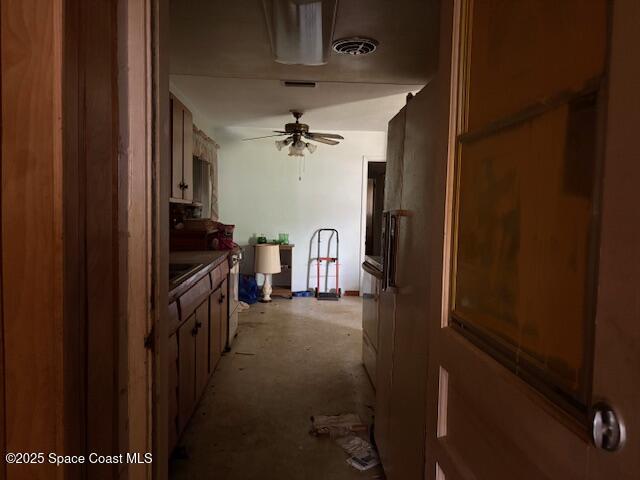 interior space with a ceiling fan and visible vents