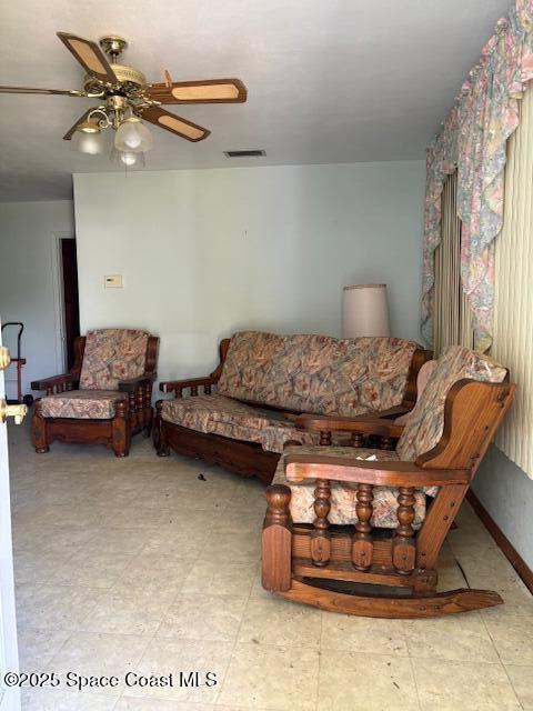 living area with visible vents and a ceiling fan