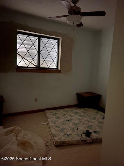 unfurnished bedroom with baseboards, multiple windows, and carpet floors