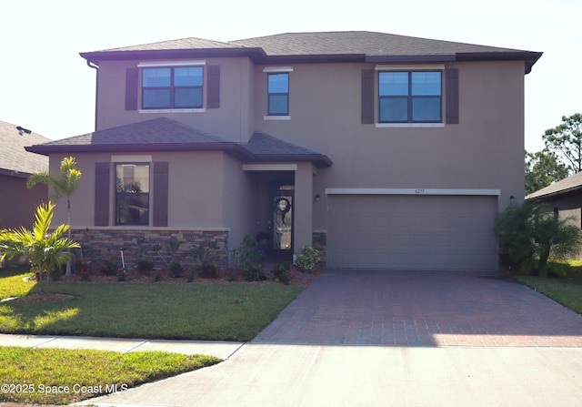 view of front facade featuring a front lawn, stucco siding, decorative driveway, a garage, and stone siding