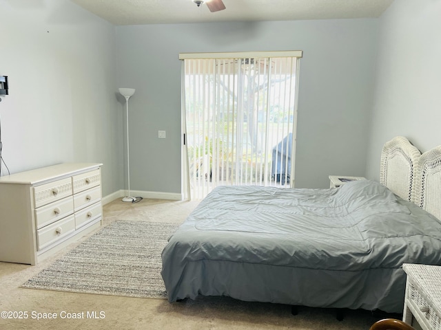 bedroom with access to exterior, light colored carpet, and baseboards