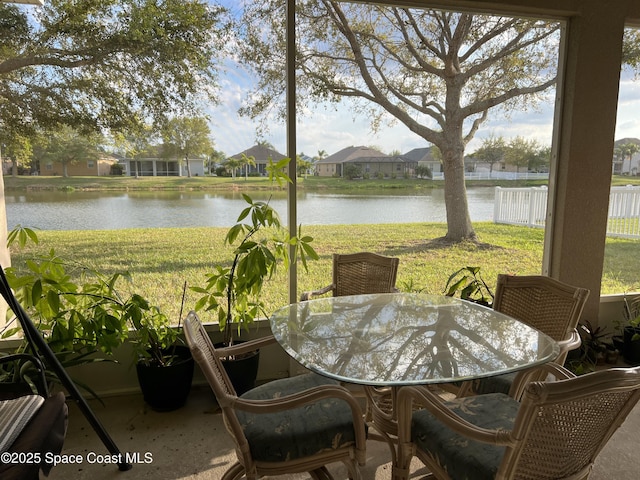 sunroom / solarium featuring a water view and plenty of natural light