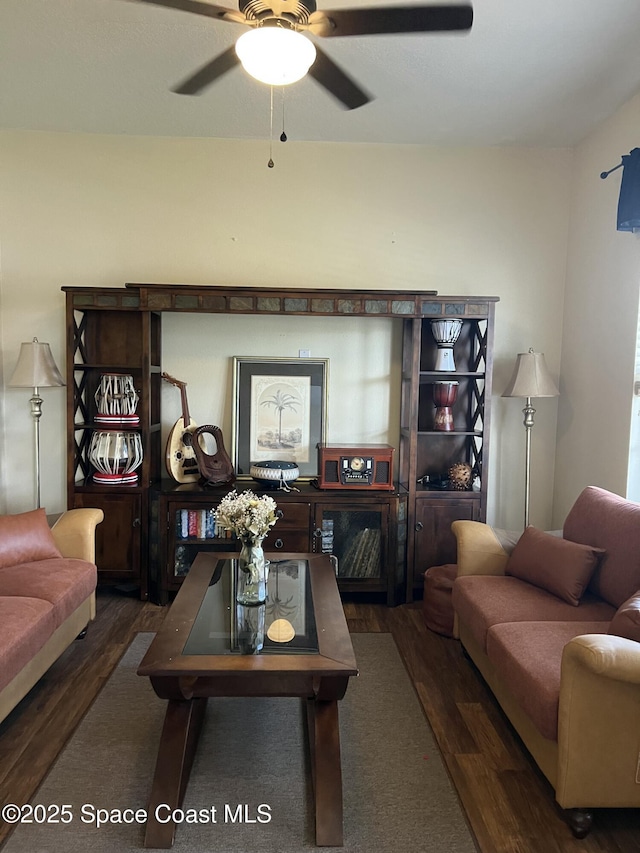 living area featuring ceiling fan and wood finished floors