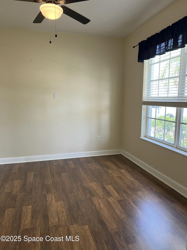 1521 Bridgeport Cir, Rockledge, FL 32955 - empty room featuring dark wood-style flooring, baseboards, and a ceiling fan