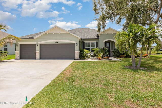 view of front of house featuring stucco siding, driveway, stone siding, a front yard, and an attached garage