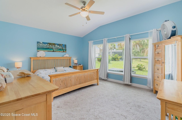 carpeted bedroom featuring vaulted ceiling, baseboards, and ceiling fan