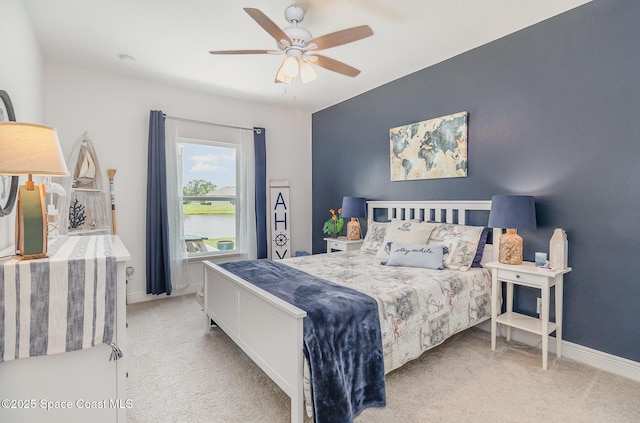 carpeted bedroom featuring baseboards and ceiling fan