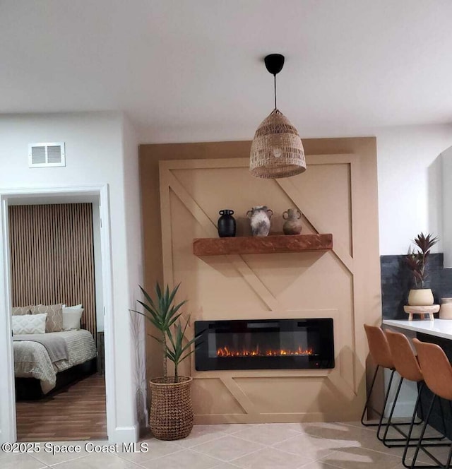 details with a glass covered fireplace and visible vents