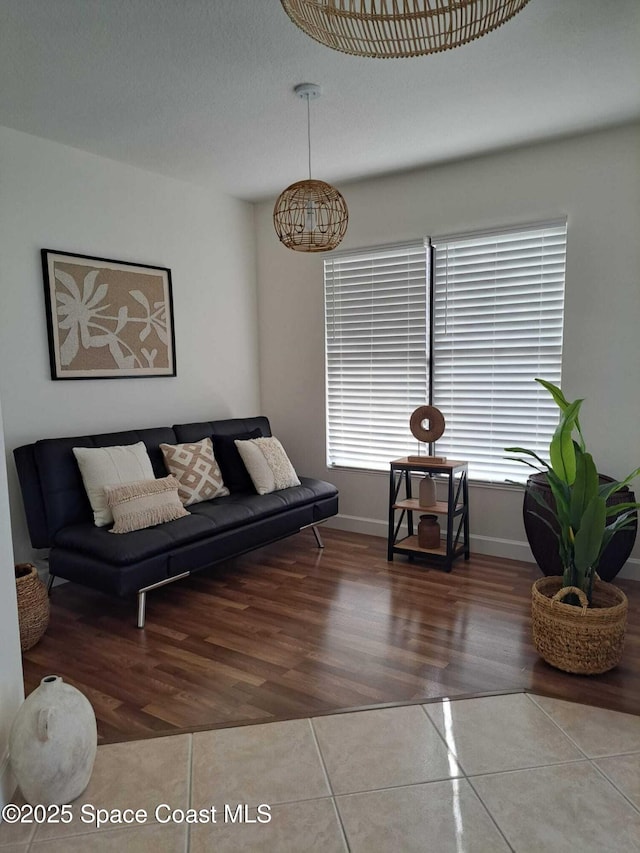 living room featuring tile patterned flooring and baseboards