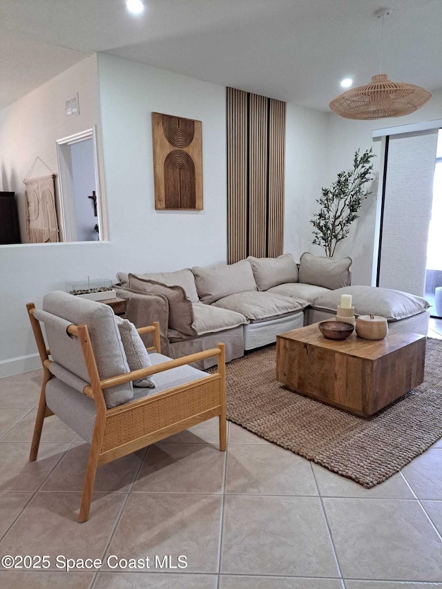 tiled living area featuring recessed lighting