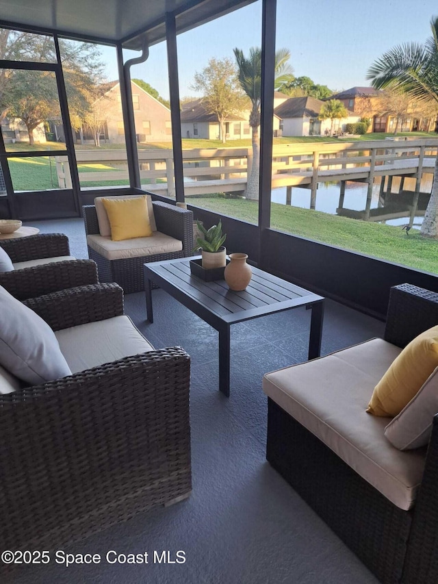 sunroom / solarium with a wealth of natural light and a water view