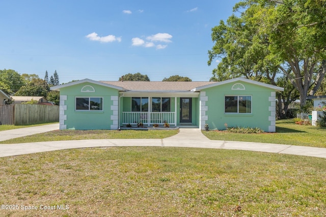 single story home with a porch, concrete driveway, a front lawn, and fence