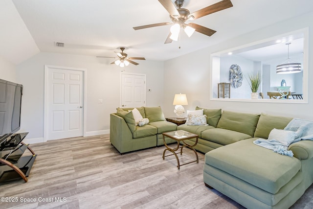 living area featuring light wood-type flooring, baseboards, visible vents, and a ceiling fan