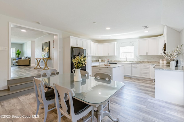 dining space featuring visible vents, recessed lighting, and light wood-type flooring