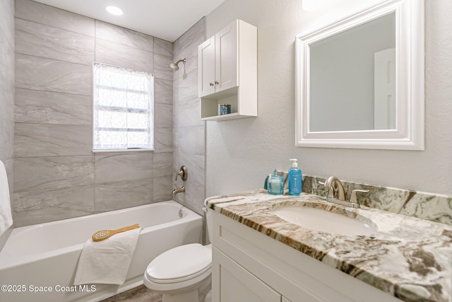 full bath featuring shower / bathing tub combination, toilet, and vanity