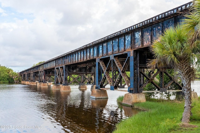 view of property's community with a pier and a water view