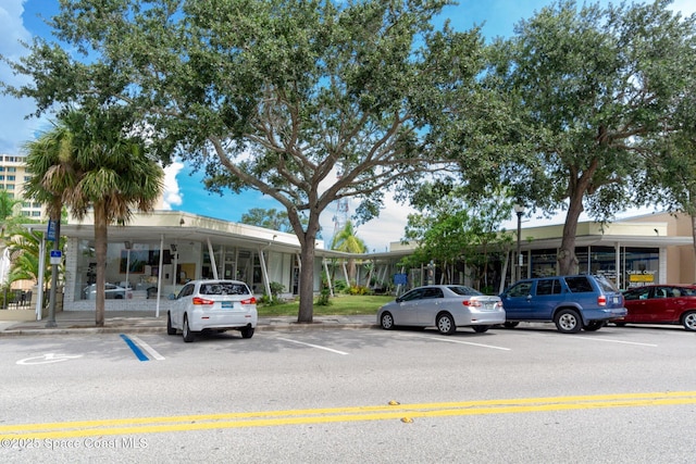 view of property featuring uncovered parking