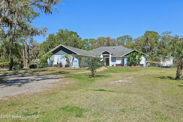 view of front of property with driveway, a front lawn, and fence