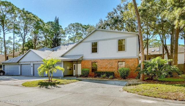 view of front of home featuring a garage, brick siding, and concrete driveway