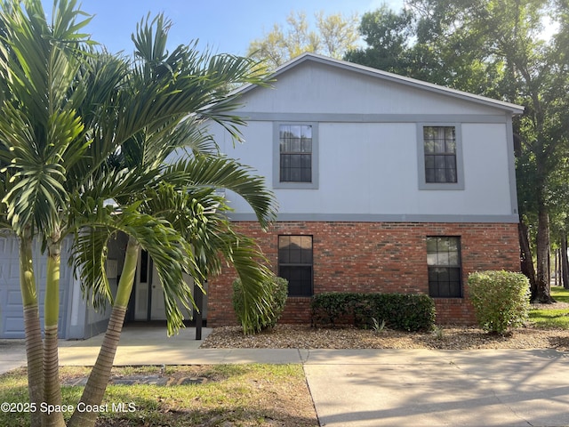 view of front of property with concrete driveway and brick siding