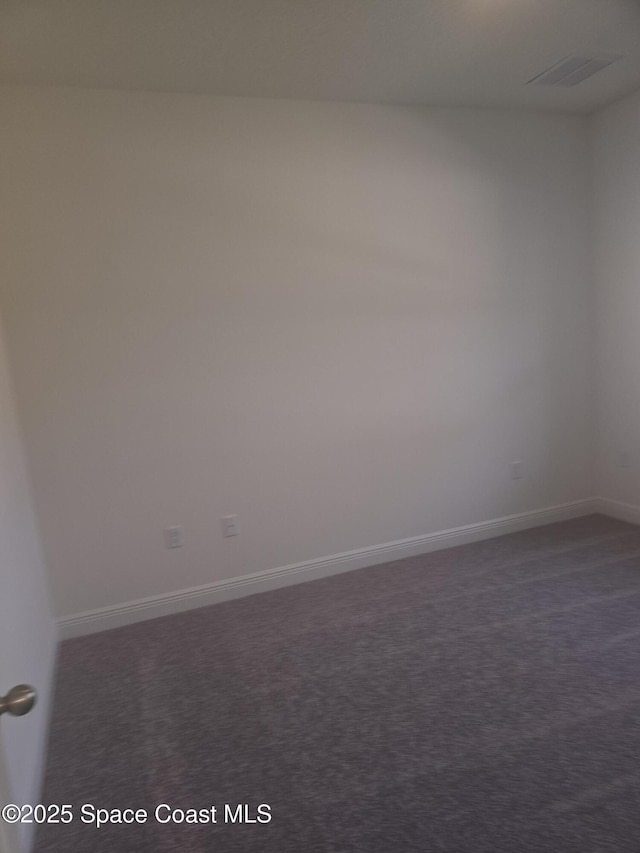 unfurnished room with visible vents and baseboards