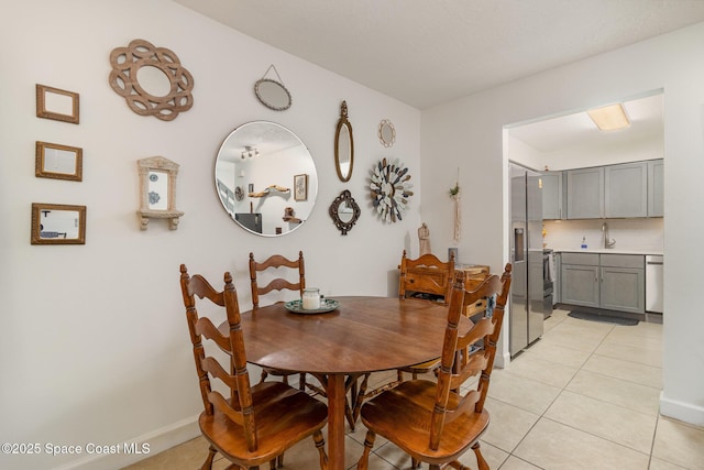 dining room with light tile patterned floors and baseboards