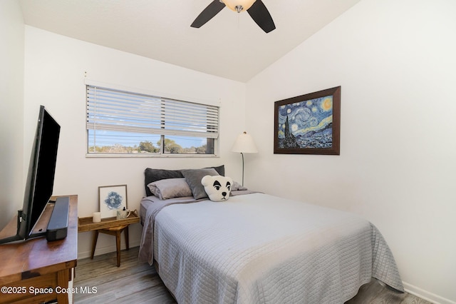 bedroom with ceiling fan, baseboards, lofted ceiling, and wood finished floors