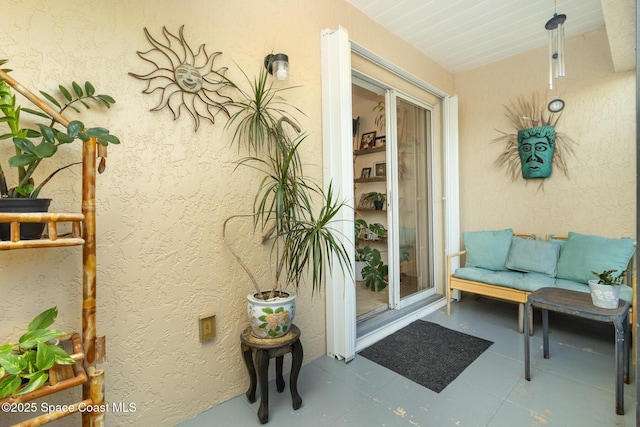 entrance to property featuring stucco siding