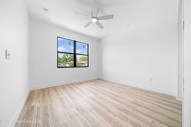 unfurnished room with baseboards, light wood-style floors, and ceiling fan