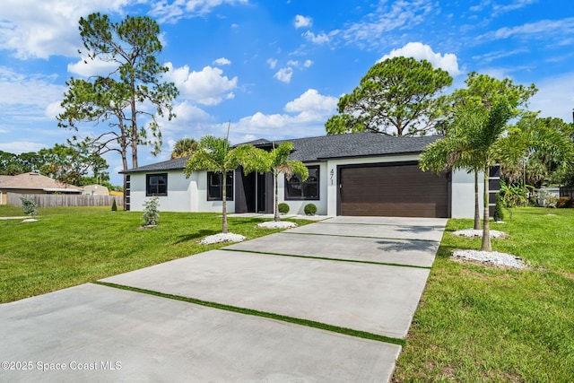 view of front of house featuring stucco siding, fence, concrete driveway, a front yard, and a garage