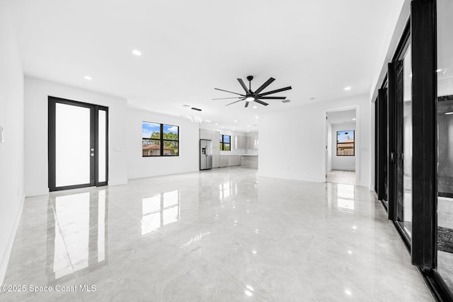 unfurnished living room featuring recessed lighting, marble finish floor, and a ceiling fan