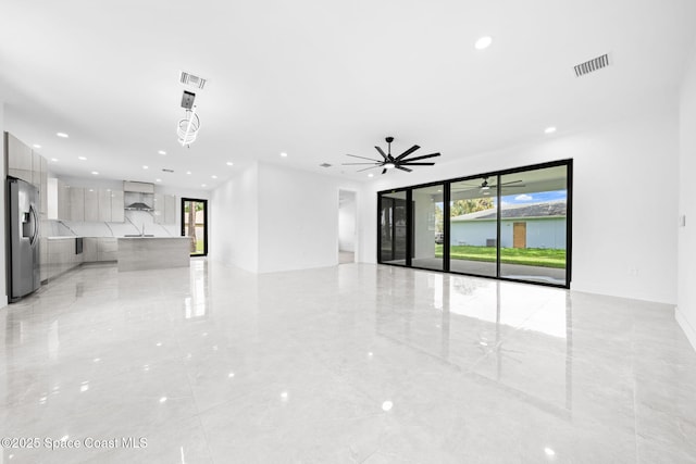 unfurnished living room with recessed lighting, visible vents, and marble finish floor