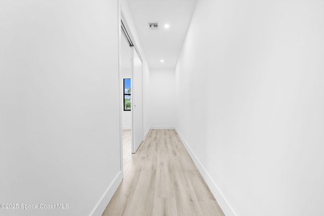 corridor featuring light wood finished floors, visible vents, recessed lighting, and baseboards