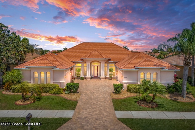 3338 Cappio Dr, Melbourne, FL 32940 - mediterranean / spanish home with a tiled roof, a garage, decorative driveway, and stucco siding