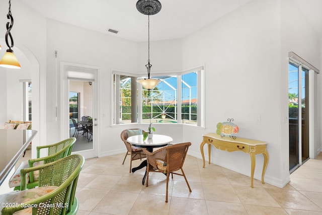 3338 Cappio Dr, Melbourne, FL 32940 - dining room with a high ceiling, light tile patterned floors, baseboards, and visible vents