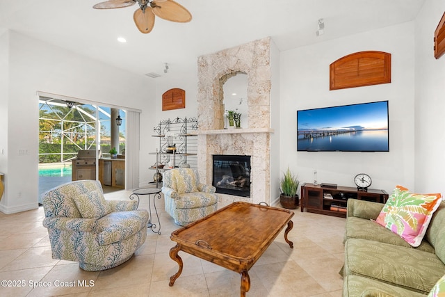 3338 Cappio Dr, Melbourne, FL 32940 - living area with a sunroom, a high end fireplace, a ceiling fan, and tile patterned flooring