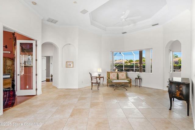 3338 Cappio Dr, Melbourne, FL 32940 - living area with arched walkways, a high ceiling, light tile patterned floors, and crown molding