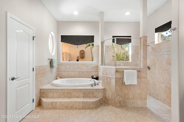3338 Cappio Dr, Melbourne, FL 32940 - bathroom featuring tile patterned flooring, a garden tub, and walk in shower