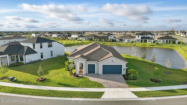 birds eye view of property featuring a water view and a residential view